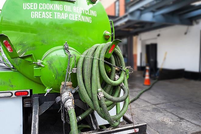 a grease trap being pumped by a sanitation technician in Gibbsboro NJ